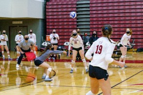 Volleyball team circling up before a game.